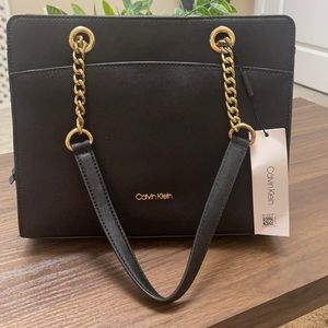 CALVIN KLEIN NWT black purse w/gold hardware. One zip, 3 magnetic snap pockets